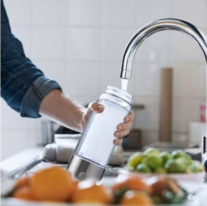 Filling the Aquivor bottle at the tap
